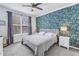 Inviting bedroom with floral accent wall, comfortable bed, and natural light from the window at 4221 W Spruce St # 1325, Tampa, FL 33607