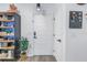 Inviting entryway with a white door, stylish light fixture, and contemporary decor at 4221 W Spruce St # 1325, Tampa, FL 33607