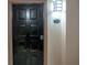 Classic black front door with elegant hardware and a well-lit entryway, unit 1325 at 4221 W Spruce St # 1325, Tampa, FL 33607