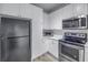 Well-equipped kitchen featuring stainless steel appliances and ample white cabinet space at 4221 W Spruce St # 1325, Tampa, FL 33607