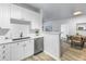 Bright kitchen featuring white cabinets, modern appliances, and a view into the dining area at 4221 W Spruce St # 1325, Tampa, FL 33607