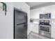 Well-equipped kitchen featuring stainless steel appliances and ample white cabinet space at 4221 W Spruce St # 1325, Tampa, FL 33607