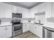 Modern kitchen with white cabinets, stainless steel appliances and subway tile backsplash at 4221 W Spruce St # 1325, Tampa, FL 33607
