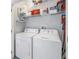 Bright laundry room features washer, dryer, and storage shelves for organization at 4221 W Spruce St # 1325, Tampa, FL 33607