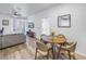 Open living area with gray sofa, television, and a dining area with round table at 4221 W Spruce St # 1325, Tampa, FL 33607