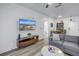 Cozy living room featuring stylish furniture, wood flooring, and a mounted television at 4221 W Spruce St # 1325, Tampa, FL 33607