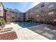 Community swimming pool with lounge chairs and a beautifully designed brick paver deck at 4221 W Spruce St # 1325, Tampa, FL 33607