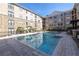 A clear shot of the lovely pool, with lounge chairs and a pergola located in the Villa Sonoma community at 4221 W Spruce St # 1325, Tampa, FL 33607