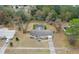 Expansive aerial view of a home featuring a fenced yard, pool, mature trees, and a sprawling lawn at 4553 Kirkland Ave, Spring Hill, FL 34606
