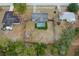 This aerial view captures a home with a screened-in pool, surrounded by mature trees at 4553 Kirkland Ave, Spring Hill, FL 34606