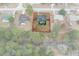 Aerial view of property highlighted, showcasing pool and serene natural surroundings at 4553 Kirkland Ave, Spring Hill, FL 34606