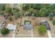 Aerial shot of a home surrounded by mature trees and a fenced yard, with an inviting backyard pool at 4553 Kirkland Ave, Spring Hill, FL 34606
