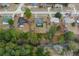 Aerial view showcases a home with a pool, nestled amongst lush greenery and a tranquil stream at 4553 Kirkland Ave, Spring Hill, FL 34606