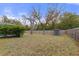 Large backyard features mature trees, a wood fence and a storage shed at 4553 Kirkland Ave, Spring Hill, FL 34606