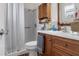 Functional bathroom with a shower and tub combo and a dark wood vanity for storage at 4553 Kirkland Ave, Spring Hill, FL 34606