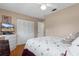 Cozy bedroom with a ceiling fan, a closet, and a decorative quilt on the bed at 4553 Kirkland Ave, Spring Hill, FL 34606