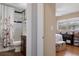 A bedroom connected to a bathroom with a window for natural light and wood flooring at 4553 Kirkland Ave, Spring Hill, FL 34606