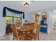 Inviting dining area, featuring a wooden table set and access to the screened in patio at 4553 Kirkland Ave, Spring Hill, FL 34606