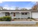 A well-maintained single-story home with a covered front porch and a tidy front garden at 4553 Kirkland Ave, Spring Hill, FL 34606