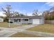 Single story home featuring an attached garage, a long driveway, and easy-to-maintain yard at 4553 Kirkland Ave, Spring Hill, FL 34606