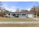 Charming single-story home with a well-maintained lawn, covered porch, and attached garage, offering curb appeal at 4553 Kirkland Ave, Spring Hill, FL 34606