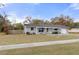 Charming single-story home with a well-manicured front lawn and mature landscaping at 4553 Kirkland Ave, Spring Hill, FL 34606