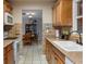 Charming kitchen with wood cabinets, brick accents, and modern appliances, flowing into the adjacent dining area at 4553 Kirkland Ave, Spring Hill, FL 34606