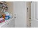 Functional laundry room with washer and dryer hookups, storage shelving, and an exterior access door at 4553 Kirkland Ave, Spring Hill, FL 34606