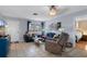 Cozy living room with tiled floor, featuring comfortable seating and natural light from the window at 4553 Kirkland Ave, Spring Hill, FL 34606