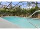 Backyard in-ground pool with a fence and a rail to provide assistance getting in and out at 4553 Kirkland Ave, Spring Hill, FL 34606