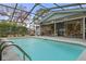 Relaxing screened-in pool area features a refreshing pool, outdoor seating and a convenient serving area at 4553 Kirkland Ave, Spring Hill, FL 34606
