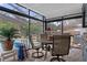 Enclosed back patio with an outdoor dining space and an in-ground swimming pool at 4553 Kirkland Ave, Spring Hill, FL 34606