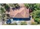 Aerial shot of the home highlighting its roof, backyard patio, and surrounding mature trees at 4604 Courtland St, Tampa, FL 33610