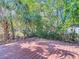 A wooden deck is surrounded by trees and lush foilage in this private backyard at 4604 Courtland St, Tampa, FL 33610