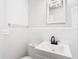 This bathroom features a modern vanity, updated fixtures, and all-white tile at 4604 Courtland St, Tampa, FL 33610