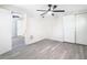 A bright bedroom features a ceiling fan, closet, wood-look floors, and neutral paint at 4604 Courtland St, Tampa, FL 33610