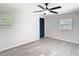 Bright bedroom with ceiling fan, wood-look floors, and two windows offering natural light at 4604 Courtland St, Tampa, FL 33610