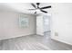 Bright bedroom with ceiling fan, wood-look floors, window, and neutral paint at 4604 Courtland St, Tampa, FL 33610