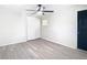 This bedroom features a ceiling fan, wood-look floors, closet, and a window for ample natural light at 4604 Courtland St, Tampa, FL 33610