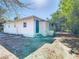 Rear exterior view of the home featuring a small raised patio area and a simple, clean design at 4604 Courtland St, Tampa, FL 33610