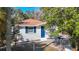 Charming house featuring a bright blue front door, complemented by white trim and a fenced front yard at 4604 Courtland St, Tampa, FL 33610