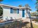 Charming home showcasing a bright blue front door, complemented by white trim and lovely brick pathway at 4604 Courtland St, Tampa, FL 33610