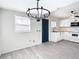 Open kitchen featuring white cabinets and modern appliances, seamlessly connected to a well-lit dining area at 4604 Courtland St, Tampa, FL 33610