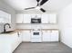 Well-lit kitchen featuring white cabinets and modern appliances providing an efficient and visually appealing cooking area at 4604 Courtland St, Tampa, FL 33610