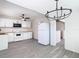 Open kitchen featuring white appliances and modern finishes, seamlessly connected to a well-lit dining area at 4604 Courtland St, Tampa, FL 33610