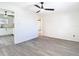 Open-concept living room features light grey wood-look flooring, neutral walls, and ceiling fans at 4604 Courtland St, Tampa, FL 33610