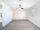 Open-concept living room features light grey wood-look flooring, neutral walls, and a ceiling fan at 4604 Courtland St, Tampa, FL 33610