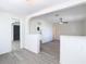 Open-concept living room boasts neutral walls, modern light grey wood-look flooring, and an arched doorway at 4604 Courtland St, Tampa, FL 33610