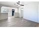 Open-concept living room with a ceiling fan and neutral paint offers a relaxing and inviting space at 4604 Courtland St, Tampa, FL 33610
