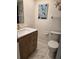 Bathroom featuring tile flooring, a wooden vanity, a mirror, and decorative artwork at 4915 Bay Ne St # 322, St Petersburg, FL 33703